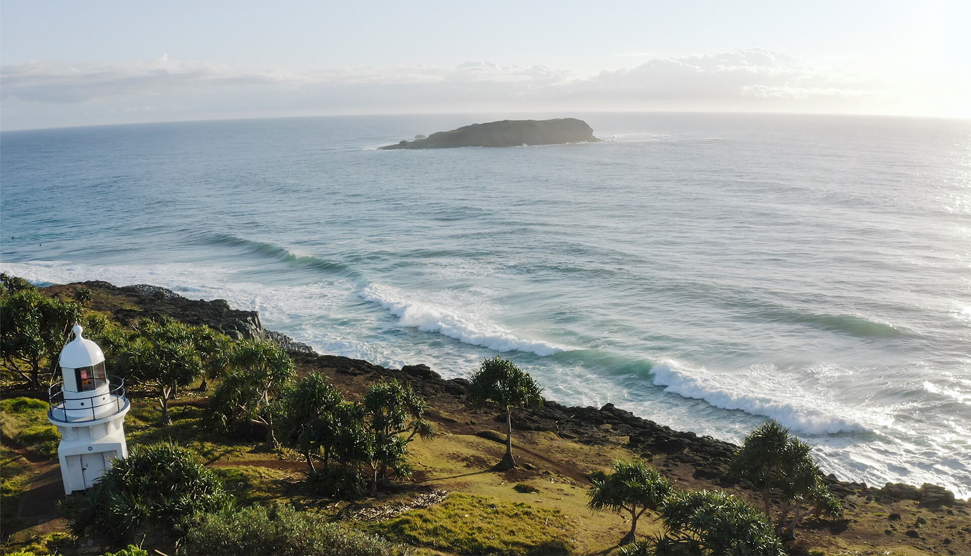 Breathtaking Tweed Coast: Golden beaches, turquoise waters, and lush landscapes under a clear blue sky.