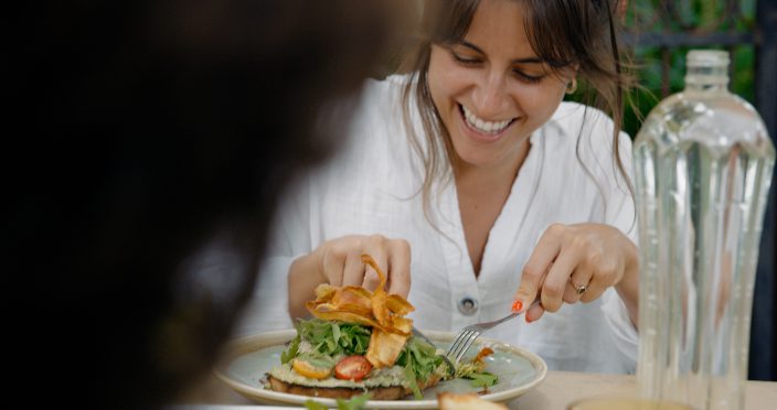girl eating dish at cafe