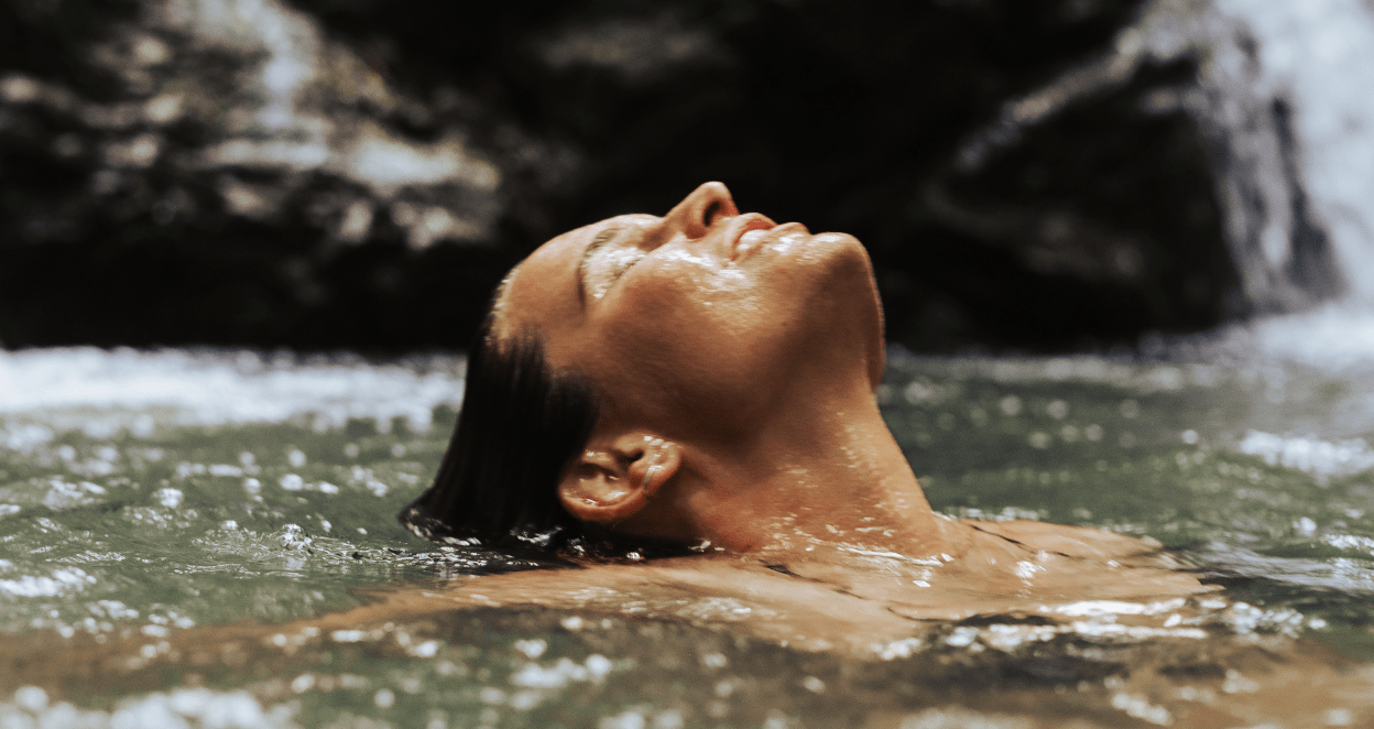 girl recharg8ing in fresh spring water on a tweed wellness experience