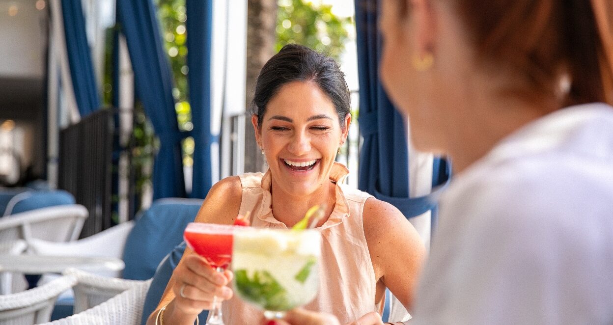 Couple drinking cocktails at Paper Daisy Restaurant in Halcyon House