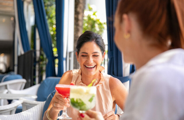 Couple drinking cocktails at Paper Daisy Restaurant in Halcyon House
