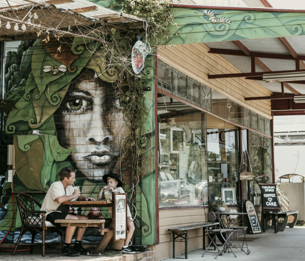 Father and son having drink outside of Tyalgum general Store