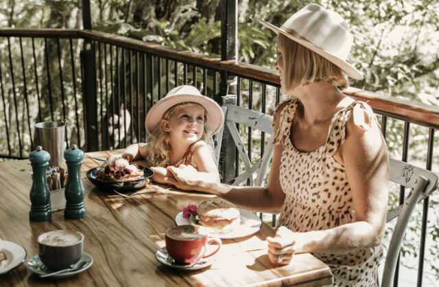 Mum and daughter eating breakfast at Crystal Creek Estate