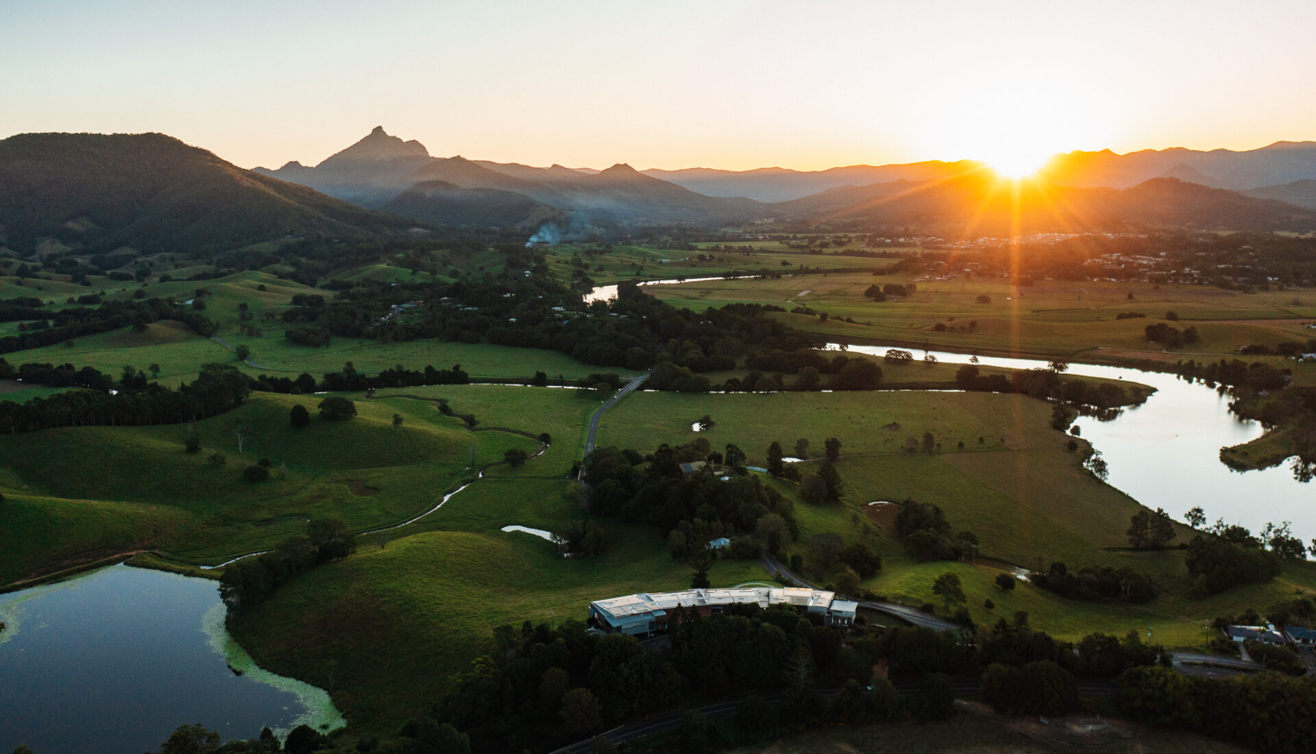 A stunning picture of the Tweed Valley showcasing the winding Tweed River surrounded by vibrant greenery. Visit The Tweed | The Perfect Business Event Destination