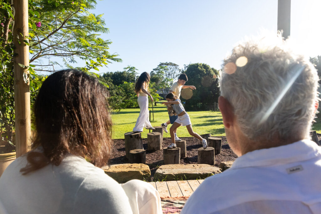 Parents watching kids play at Farm and Co