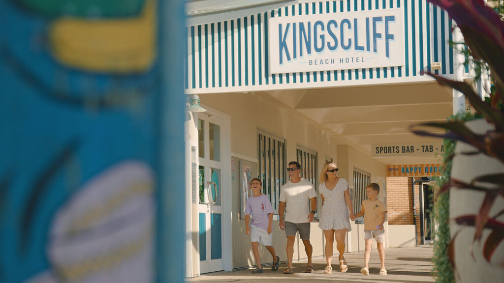 Family walk into kingscliff beach hotel