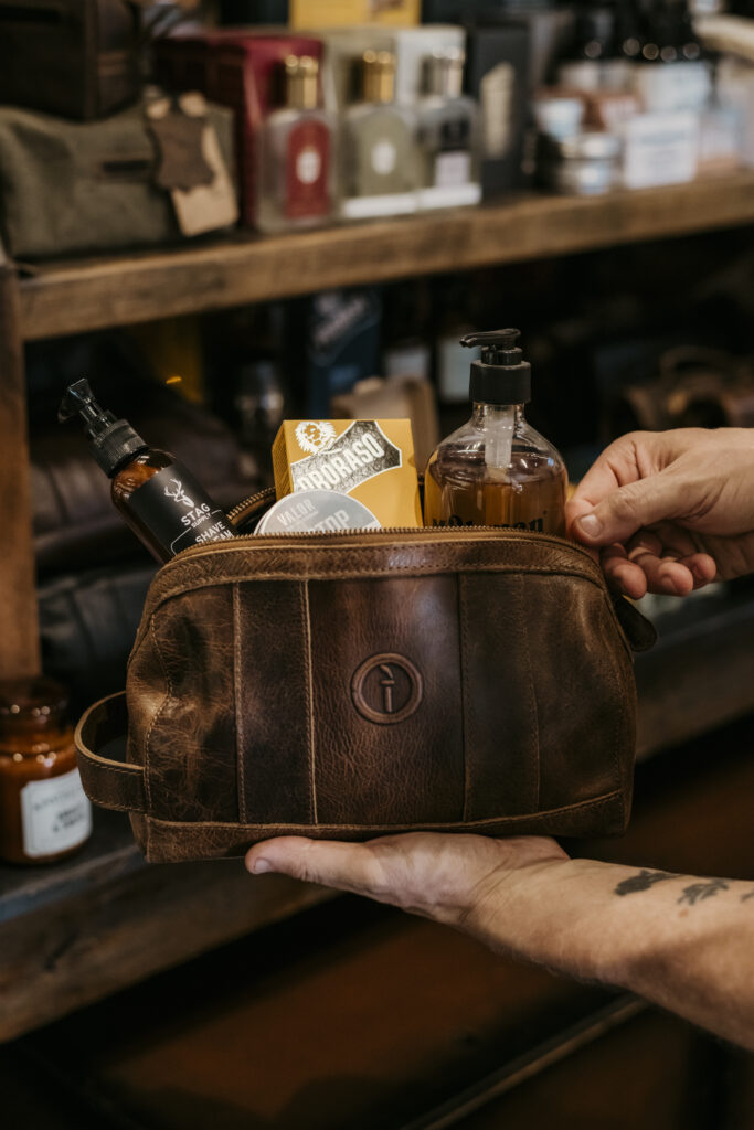leather toiletry bag full of men's grooming and hygiene products 