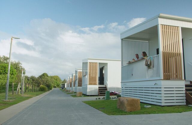 Couple on deck of sunrise cabins at Tweed Holiday Parks Kingscliff North