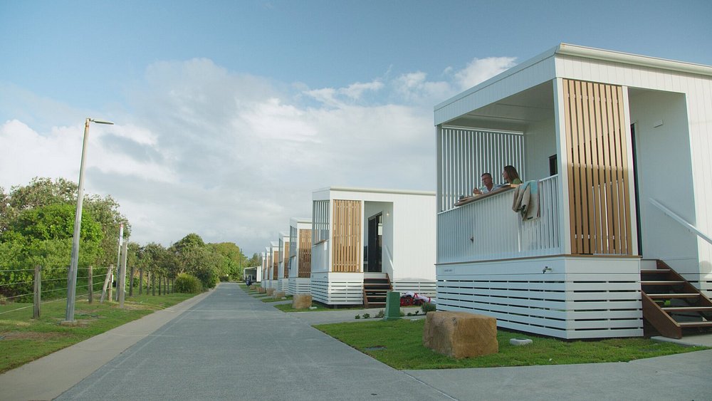 Couple on deck of sunrise cabins at Tweed Holiday Parks Kingscliff North
