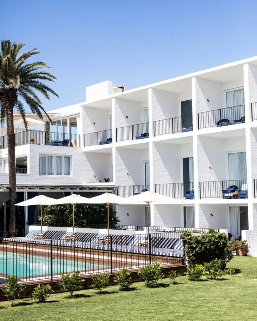 view of pool and white, luxury hotel