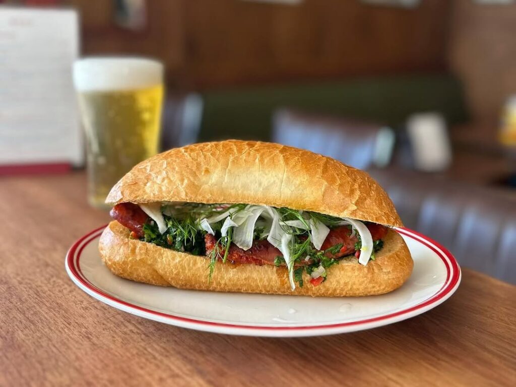 sandwhich on handmade roll with beer