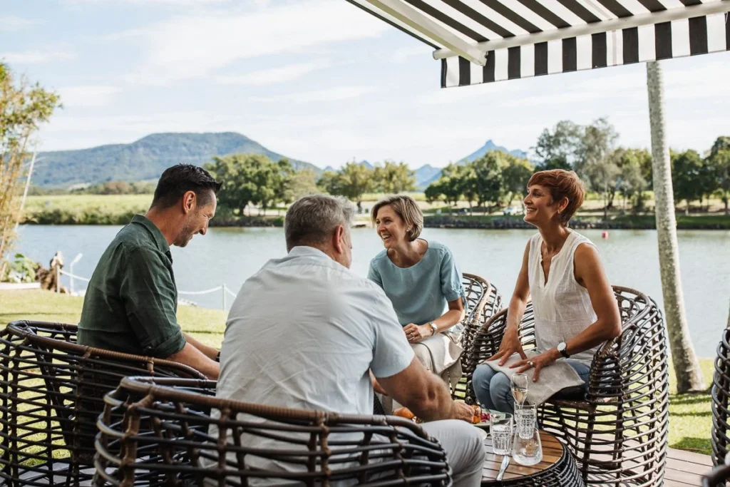 Friends enjoy alfresco dining with river and mountain view at Tweed River House