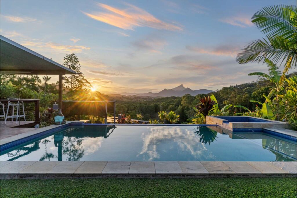 Pool at eco lodge with mountain view at sunset