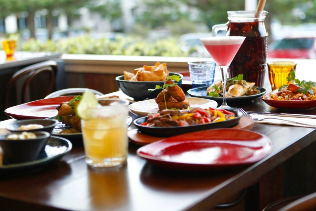 table of colourful cocktails and mexican inspired dishes