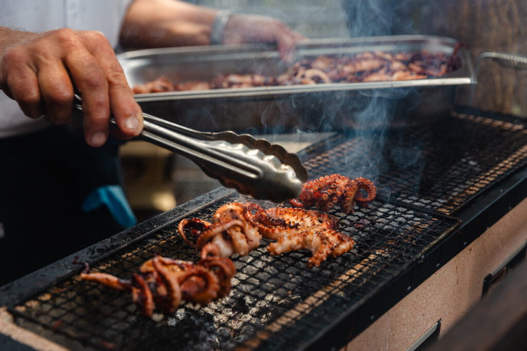 chef grilling octopus on hibachi