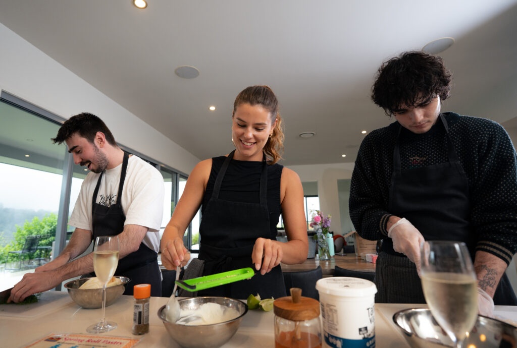 group cook together in rural retreat near gold coast