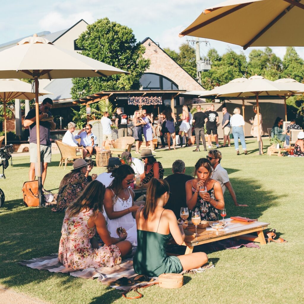girls having long lunch on lawn at husk farm distillery in northern nsw