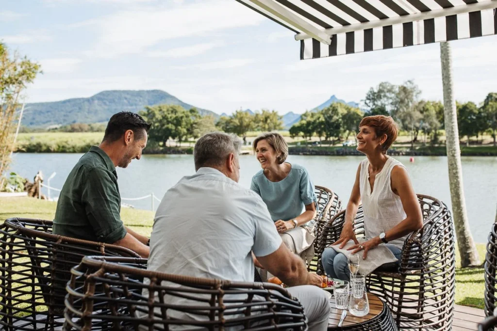 Group enjoy cocktails with a view at Tweed River House lawn bar in Murwillumbah